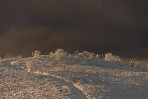 Dramatic winter mountain landscape in Bieszczady with dark storm clouds gat.. Stock Photos
