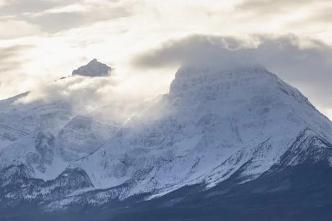Dramatic winter mountain landscape with clouds and sunlight casting shadows.. Foto stock