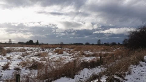 Dramatic Winter Sky Over Snow-Covered Rural Landscape Stock Footage 271200767