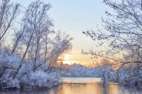 Dramatic winter sunset with the view of a river and everything frozen by the  Stock Photos