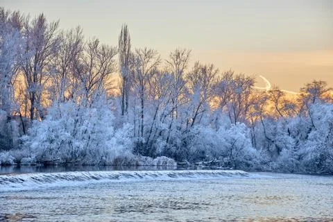 Dramatic winter sunset with the view of a river and everything frozen by the  Stock Photos
