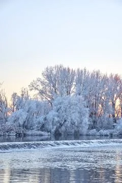 Dramatic winter sunset with the view of a river and everything frozen by the  Stock Photos