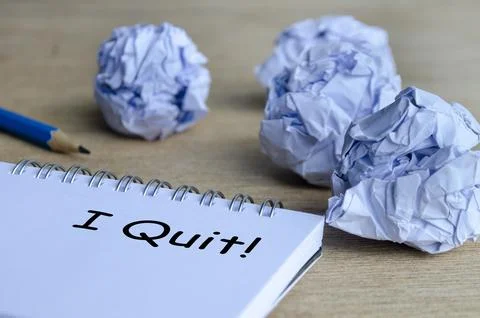 A dramatic workspace scene with crumpled paper surrounding a notepad that d.. Foto stock