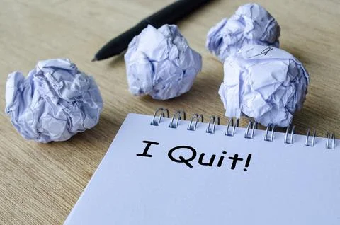 A dramatic workspace scene with crumpled paper surrounding a notepad that d.. Photos