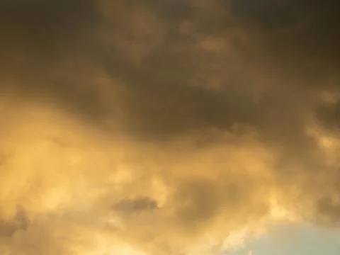 Dramatic yellow sky and dark clouds before a thunderstorm Stock Photos