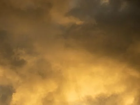 Dramatic yellow sky and dark clouds before a thunderstorm Stock Photos