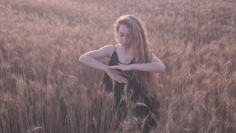 Dramatic young woman choreography dance on the golden wheat field on the ground  Stock Footage 200907486