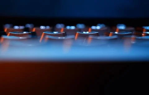 Dramatically illuminated keyboard closeup background Stock Photos