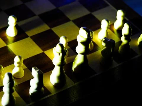 Dramatically lit chess pieces on a board Stock Photos