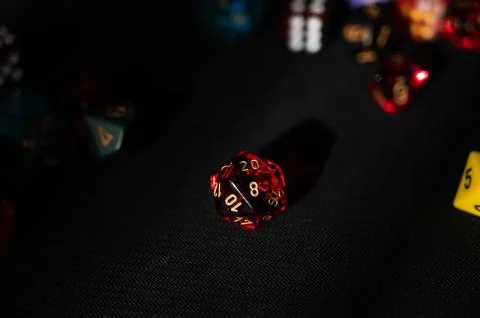 Dramatically Lit Translucent Red D20 Die Stock Photos