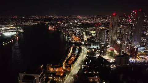 Dramtic Night view Canary Wharf riverside apartments  London drone,aerial Stock Footage 322932002