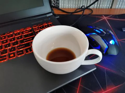 Drank coffee in a white cup at the computer at work. Stock Photos