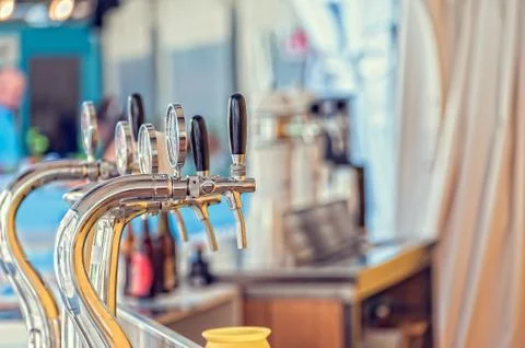 Draught beer taps in a bar. Stock Photos