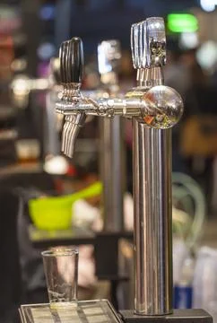Draught beer taps in a bar. Stock Photos