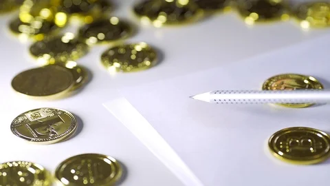 To draw bitcoin on paper. Gloss of coins. UHD Stock Footage 88481864