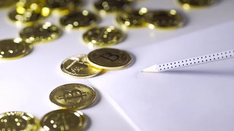 To draw bitcoin on paper. Gloss of coins. 4k Stock Footage 88482004