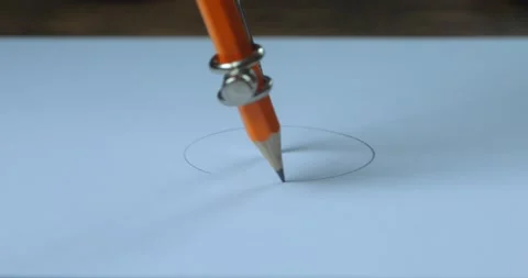 Draw a circle on paper using a compass and pencil. Close-up of a person drawing Stock Footage 236930321