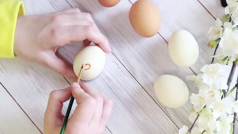 Draw a heart on an egg, preparing for Easter Stock Footage 233489531