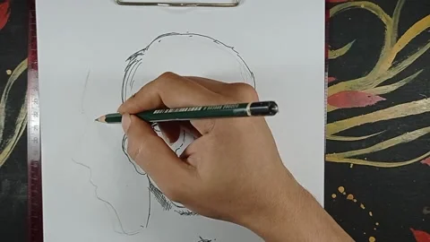 Draw a sketch of a man's face Stock Footage 221130123