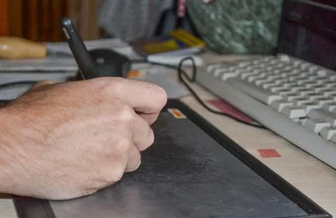 Draw write on a graphics tablet with a stylus. Stock Photos