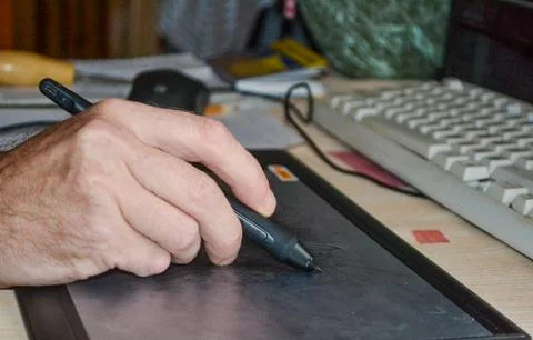 Draw write on a graphics tablet with a stylus. Stock Photos