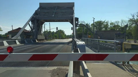 Drawbridge Begins Rising while Red Light Flashes Atop Traffic Barrier Stock Footage 91636926