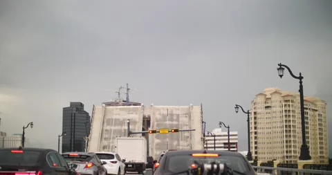 Drawbridge being let down so cars can drive across the bay Stock Footage 213140524