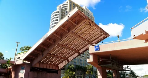 Drawbridge lowering down closing space for boat traffic in Fort Lauderdale, 4K Stock Footage 96327257