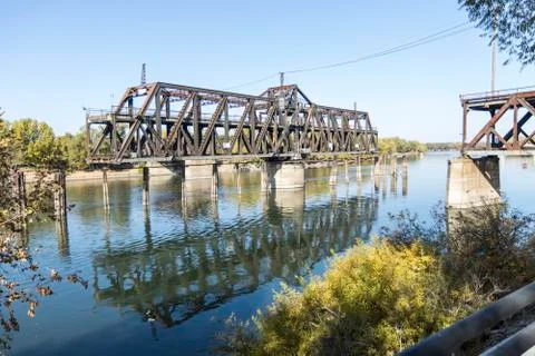 Drawbridge in mid move partially open to let a ship through Stock Photos