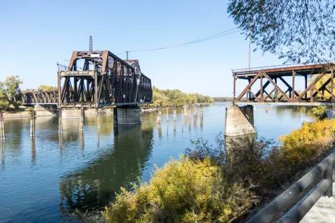 Drawbridge in mid move partially open to let a ship through Stock Photos