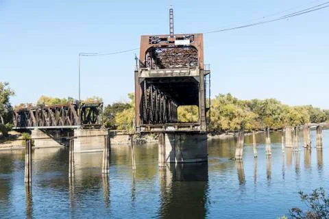Drawbridge in mid move partially open to let a ship through Stock Photos