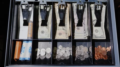 The drawer of the cash desk opens, where cash US dollars and coins lie. View Stock Footage 87969401