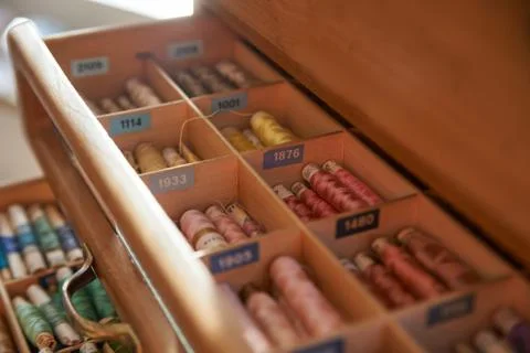 Drawer with different colored threads in it is the windfall for every housewife Stock Photos