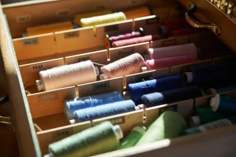 Drawer with different colored threads in it is the windfall for every housewife Stock Photos