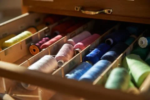 Drawer with different colored threads in it is the windfall for every housewife Stock Photos