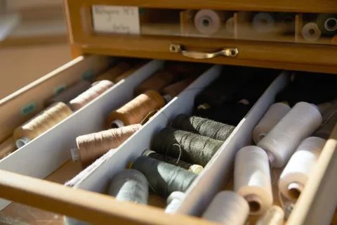 Drawer with different colored threads in it is the windfall for every housewife Stock Photos