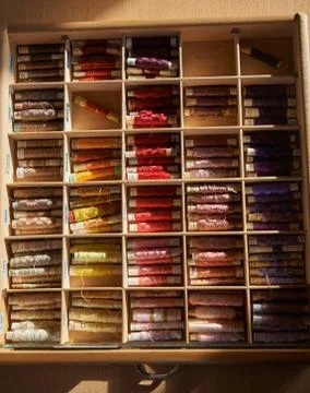 Drawer with different colored threads in it is the windfall for every housewife Stock Photos