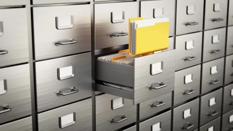 A drawer of a filing cabinet opens and a yellow folder is taken Stock Footage 285497673