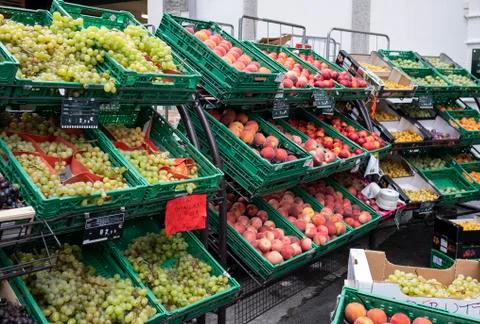 Drawers of fruit varieties of different sizes and colors in street fruit shop Stock Photos