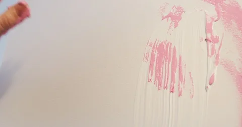 Drawing an abstract painting using bare hand and pink paint Stock Footage 126982735
