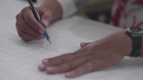 Drawing batik pattern using pencil on white fabric Stock Footage 221258339