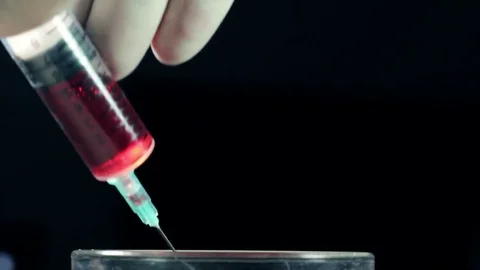 Drawing blood into syringe Stock Footage 74283850