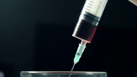 Drawing blood into syringe Stock Footage