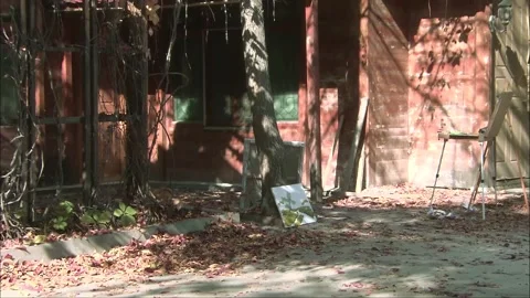 Drawing board for creative work under the trees outside the house Stock Footage 252481841