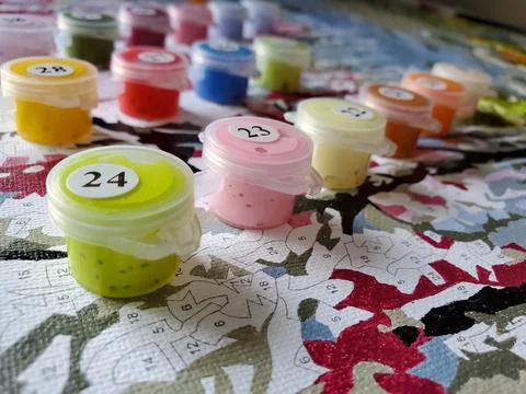 Drawing on canvas by numbers and numbered cans with bright colors on the Stock Photos