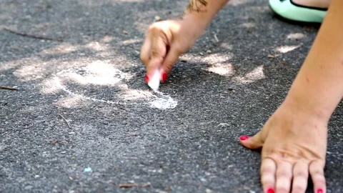 Drawing with chalk on asphalt Stock Footage 90984957
