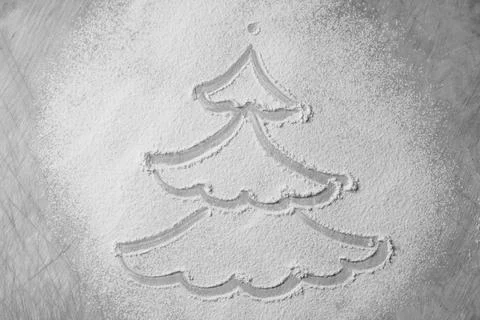 Drawing of a Christmas tree on a cutting Board made of white flour Stock Photos