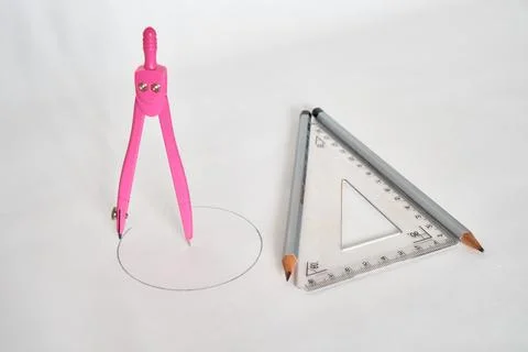 Drawing compass and triangular ruler with two pencils on a white background. Stock Photos