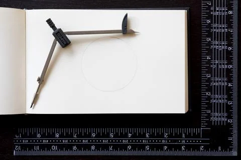 Drawing compass over notebook and Carpenter's square Stock Photos