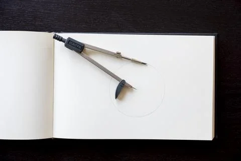 Drawing compass over notebook to personalize with the logo of your company Stock Photos